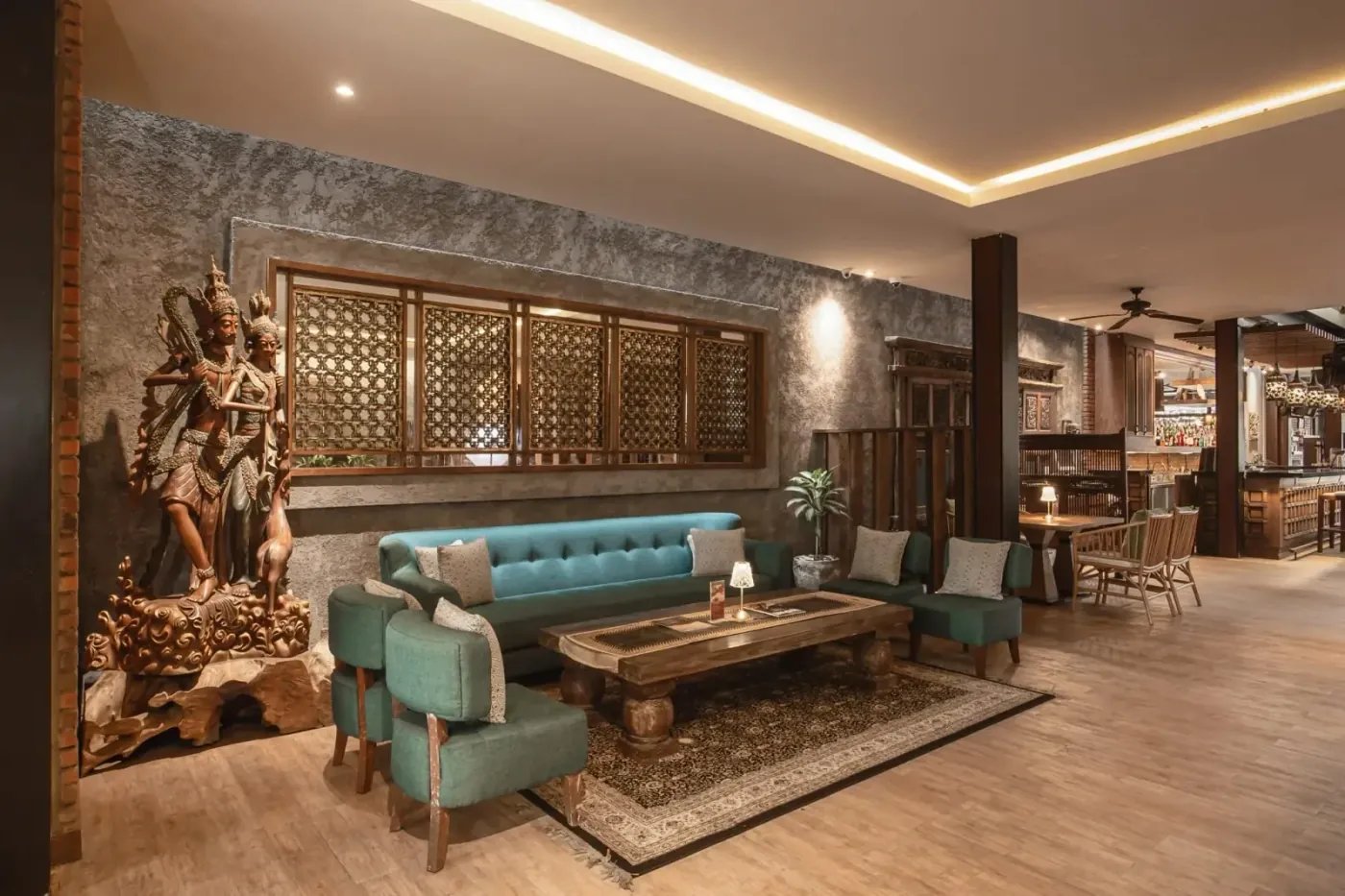 Carved wooden statues and lounge seating inside Enclave Ubud, the bistro on Hanoman street that hosts free Latin nights