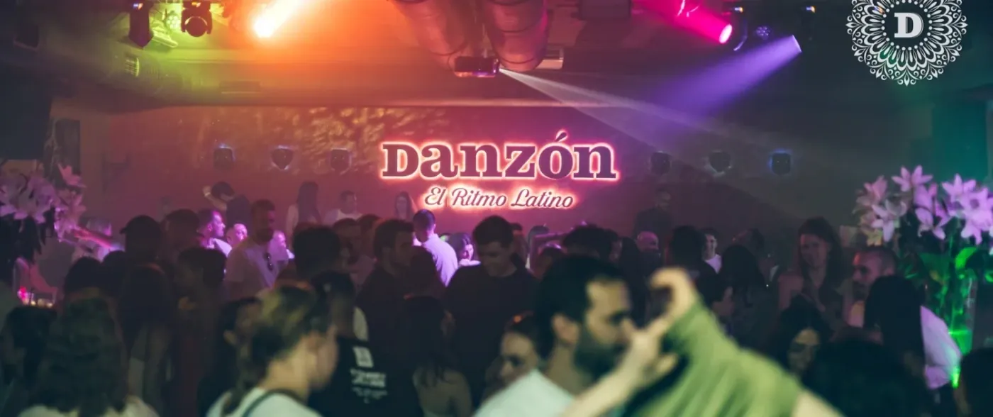 A crowded Latin night at Danzón in Vienna's first district, with the club's neon sign above the dancefloor